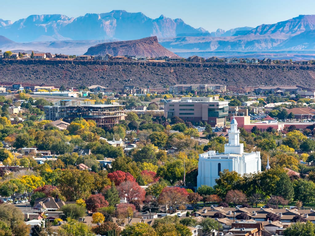 St. George, Utah temple with Zion National Park mountains in the distance